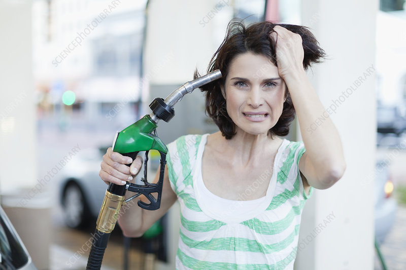 frustrated woman pumping gas into hair