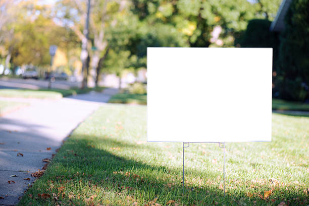 white sign with clipping path on front lawn during sunny day.